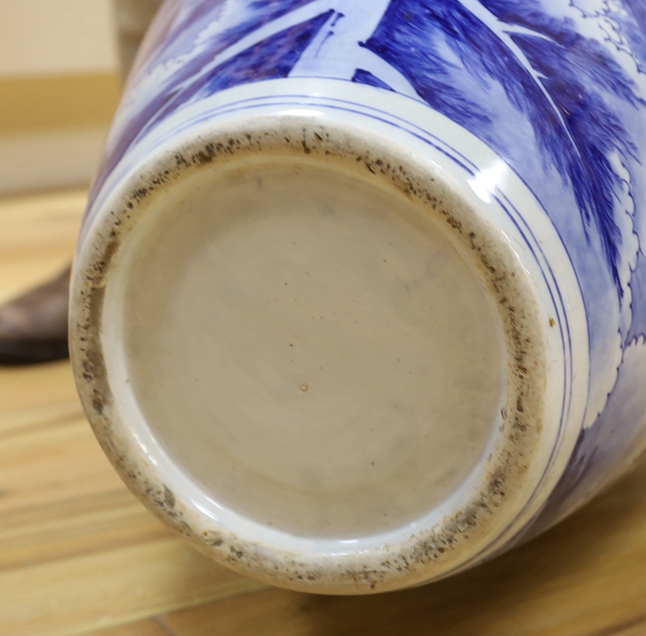 A large Japanese Arita blue and white vase, late 19th century, decorated with pine trees and mountains, 79cm high